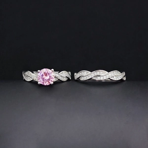 Exquisite women's silver jewelry set featuring a pink round-cut gemstone and twin pavé bands