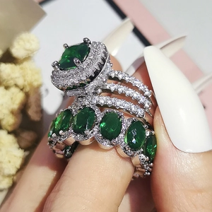Macro shot of a stacked emerald green crystal ring set with pavé cubic zirconia details