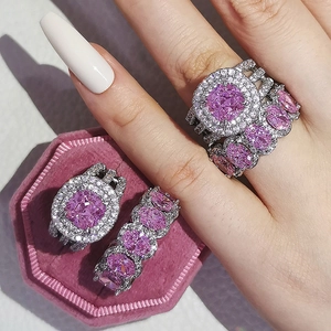 Sparkling silver ring set featuring pink emerald-cut gemstone and halo pavé diamonds