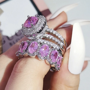 Macro detail of high-grade pink cushion-cut zircon ring set with silver-tone micro-paving