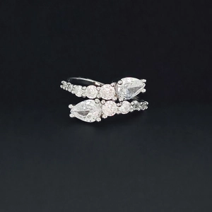 Macro detail of Toi et Moi open ring featuring pear-cut stones and cubic zirconia