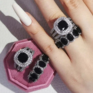 Macro detail of luxury silver ring set with emerald-cut black stones and pave diamonds