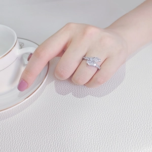 Close-up of a zircon wrap ring with pear-cut stones worn by a model in a luxury setting