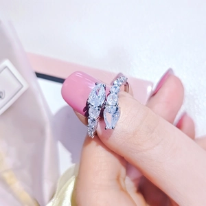 Close-up of adjustable silver snake ring with pear-cut cubic zirconia in hand