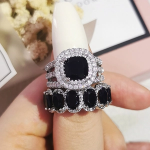 Macro detail of cushion-cut black gemstone ring set with sparkling pave diamonds