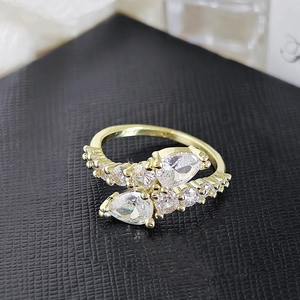 Macro shot of gold-plated ring featuring pear-cut cubic zirconia in a wrap design