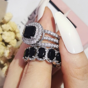 Detail of square black gemstone ring set with sparkling pave diamonds on silver band