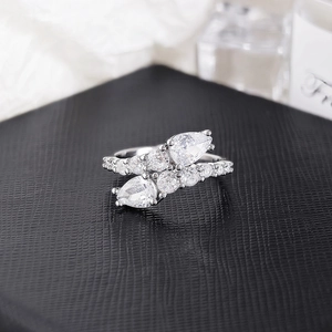Detailed macro view of pear-cut zircon stones on a silver wrap ring with micro-pave setting