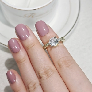 Detailed close-up of a zircon ring with six-prong setting on a gold band for women