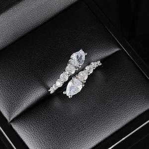 Macro detail of silver ring with pear-shaped cubic zirconia in a black leather box