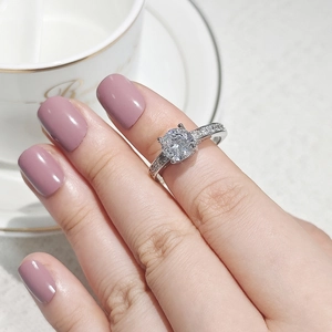 Macro view of the classic four-prong setting and brilliant round cubic zirconia silver ring