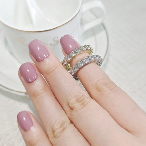 Close-up of gold and silver eternity rings with cubic zirconia on a hand