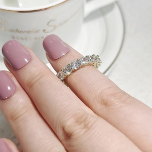Close-up of a silver band ring featuring seven sparkling round-cut cubic zirconia stones