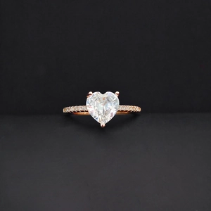 Makroaufnahme von Herzschliff-Zirkon-Ring mit Roségoldband und Pavé-Diamantbesatz