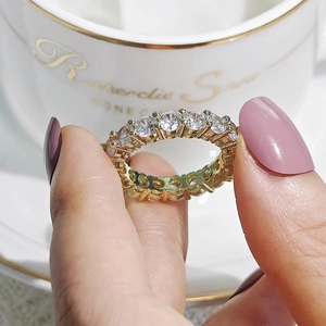 Macro detail of gold eternity ring with round-cut sparkling cubic zirconia stones