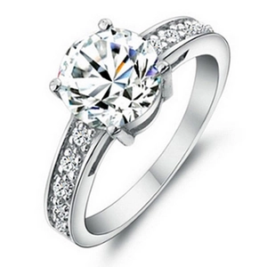 Classic silver-toned six-prong zircon ring with side pavé stones on a slim band