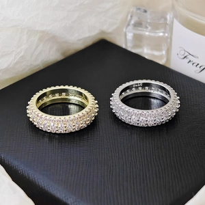 Close-up of S925 stamped silver and gold stacked rings with full pavé zircon settings