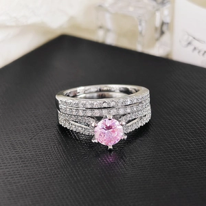 Detailed macro view of a three-piece ring set with round pink gemstone and pave accents