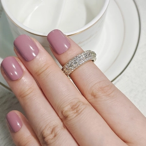 Close-up of elegant gold plated ring with triple row of sparkling cubic zirconia stones