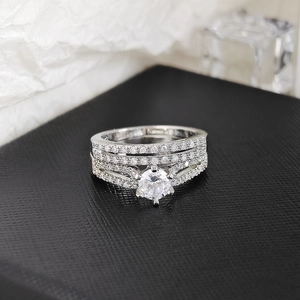 Macro detail of a three-piece stackable ring set with six-prong round cut central stone
