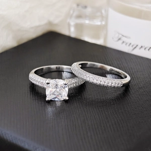 Macro shot of a square pink zircon ring set with silver band and pavé diamond details