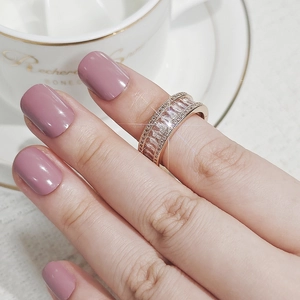 Macro shot of rose gold ring with three rows of baguette and round cut cubic zirconia