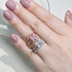 Close-up of cushion cut pink square gem ring set with pave diamonds on hand