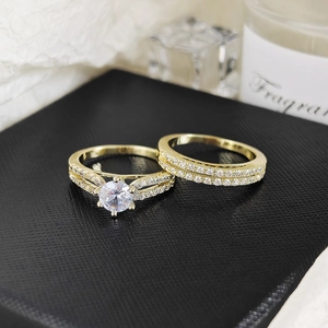 Detailed macro view of a gold-plated stacked ring set with large round-cut cubic zirconia