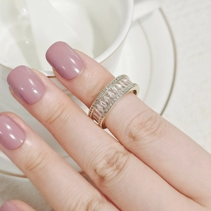 Detail of gold crystal ring featuring baguette-cut stones and pave diamonds on hand