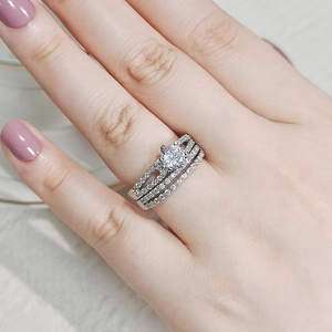 Detailed close-up of a silver stackable ring set with a round brilliant cut center stone