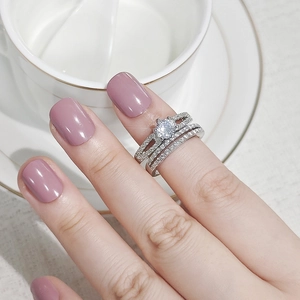 Elegant silver stackable ring set with center stone and micro-pave bands on model
