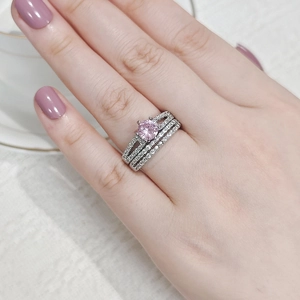 Close-up of elegant stackable silver ring set with pink zircon and micro-pave diamonds