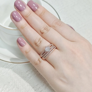 Detailed close-up of a stacked rose gold ring set with micro-pave crystals and center stone