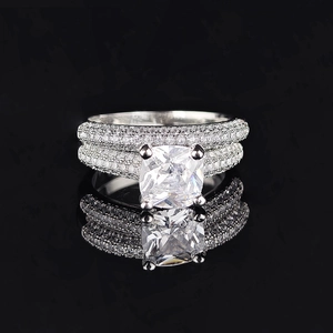 Luxurious silver ring with a large square-cut central stone and pavé-set diamond bands