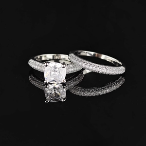 Silver cushion-cut pink crystal ring set with pavé zircon stones on black background