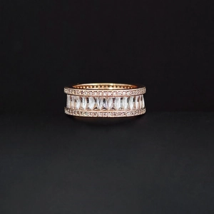 Luxurious rose gold baguette-cut diamond ring with milgrain detailing and sparkling micro-pave
