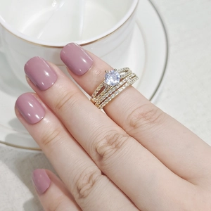 Detail of elegant gold stacked ring set with clear round zircon and pavé crystal stones