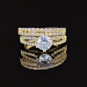 Elegant gold stacked bridal ring set with large round center stone and pave accents
