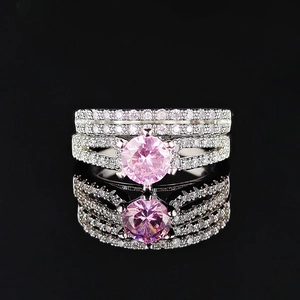 Exquisite silver-tone stackable ring set featuring a large round pink gem and micro-pave diamonds