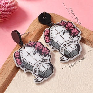 Detail view of double-sided acrylic coffin earrings with GET IN LOSER text and flowers
