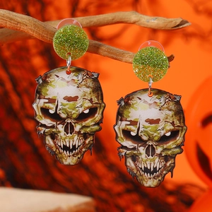 Halloween skull drop earrings with green glitter studs hanging on tree branches
