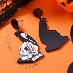 Detailed size view of Halloween acrylic skull wings earrings with orange festive background
