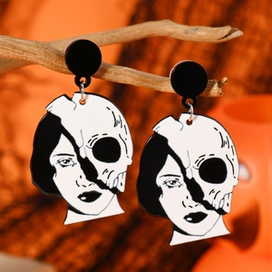 Halloween earrings featuring creative split female face and skull design in black and white