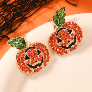 Sparkling Halloween pumpkin stud earrings with orange rhinestones and green leaf detail