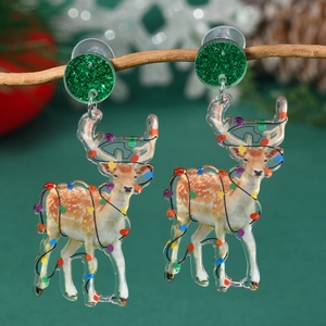 Detail of reindeer acrylic earrings with Christmas lights hanging on a natural wooden branch