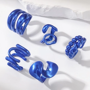 Detail of five-piece electric blue metallic jewelry set with abstract fluid geometry