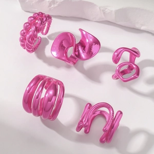 Close-up of pink metallic irregular hollow rings with liquid metal texture and lava style