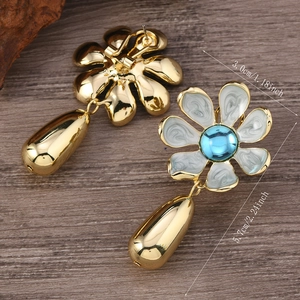 Macro view showing floral drop earrings dimensions of 3.0cm width and 5.7cm length