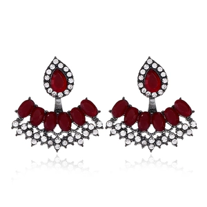 Detail of vintage fan-shaped earrings with red drop stones and white rhinestones