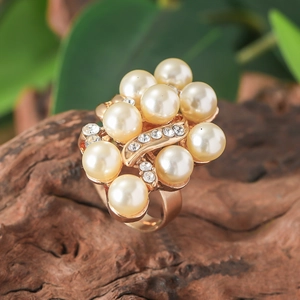 Pink cluster ring with pearls and zircons on a rose gold band in a natural setting